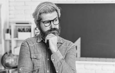 Intellectual task. Cognitive development. Teacher work at college. Inspiring to learn. Modern school. Private lesson. School projects. Back to school. Mature bearded man in glasses. Education conceptの写真素材