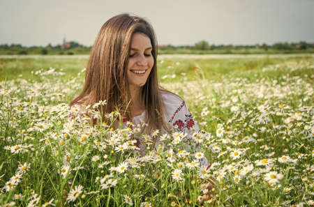 pure beauty. happy girl in chamomile flowers. summer vacation and holiday. pretty woman relax in chamomile field. enjoy meadow beauty. romantic mood. beauty of spring natureの写真素材