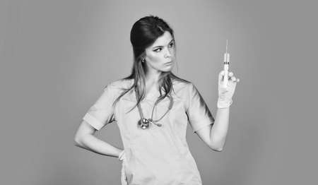 Innovation. Nurse with coronavirus vaccine in syringe. Medical injection. Pretty woman doctor syringe needle vaccination copy space. Dose injection. Vaccine development. Medicament drug. Free vaccineの写真素材