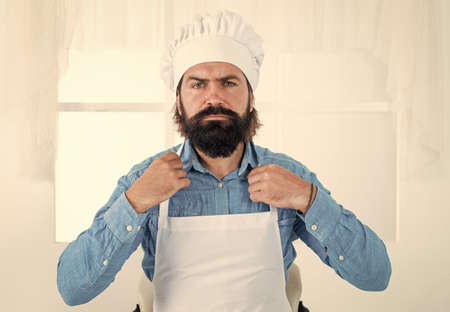 lunch time. professional restaurant cook. skilled baker wearing uniform for cooking. male chef in hat and apron prepare. handsome man with beard and moustache ready for cooking foodの写真素材