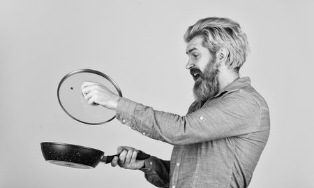 Saucepan glass lid. Nonstick pan coated polytetrafluoroethylene teflon. Man hold new brand pan. Cooking healthy food. Shopping kitchenware. Cooking utensils. Enameled cast iron cooking vesselsの写真素材