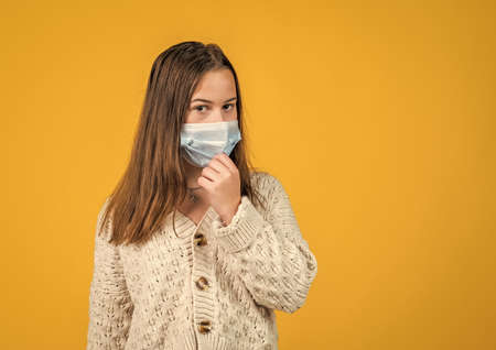 teen girl wear respirator mask while virus pandemic quarantineの写真素材