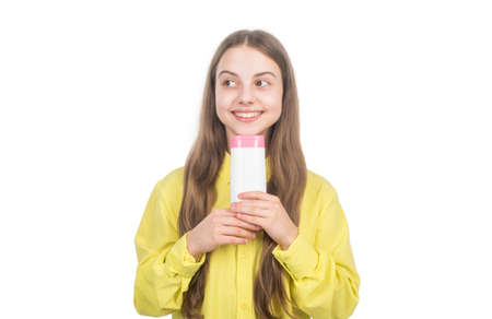 happy kid presenting shampoo or hair body conditioner bottle isolated on white, daily habitsの写真素材