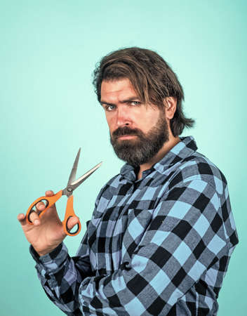 sharp styled. andsome hipster with moustache. hairdresser tool. barbershop. mature barber with scissors. bearded man with scissors. brutal guy cut his hair. hairstyle male fashion look.の写真素材