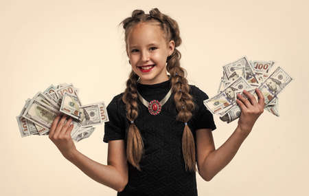 stylish child with retro look has money cash dollar in suitcase isolated on white, lottery winerの写真素材