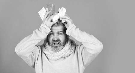 ill man at home. sneezing and coughing. man got flu, having runny nose. from china. cough cold and runny nose remedy. How to bring fever down. man ready to take a pill. copy spaceの写真素材