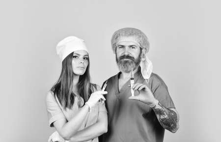 nurse and doctor use syringe. health worker make injection. hpv vaccine in syringe. Physician give remedy against virus. virus epidemic from china. protect immunityの写真素材