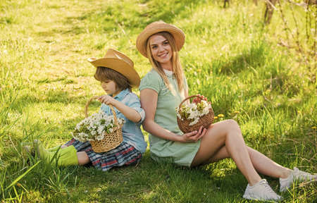 Always happy together. cheerful child with mother play outdoors in park. Mother with a baby. Son with mum in spring. Family connection and motherhood. upbringing. Portrait mom and little son outdoorの写真素材