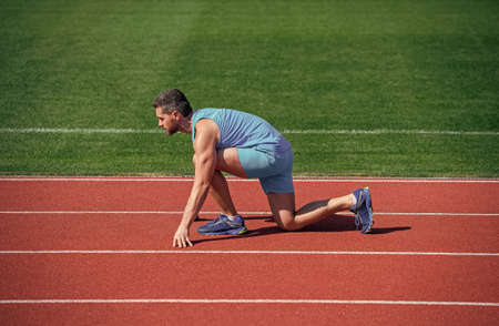 Runner ready to go. Athlete runner prepare to race at stadium. Running tips for beginners.の写真素材