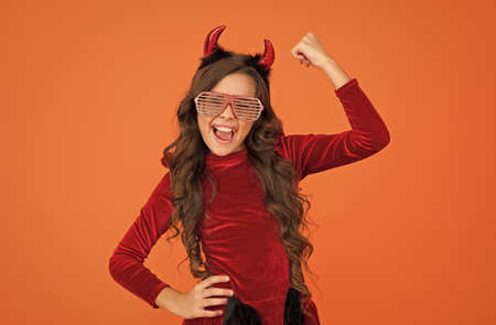 finally this happened. be in trend. happy halloween. smiling child in devil horns. kid wear funny party glasses. just having fun. childhood happiness. teen girl ready to celebrate costume partyの写真素材