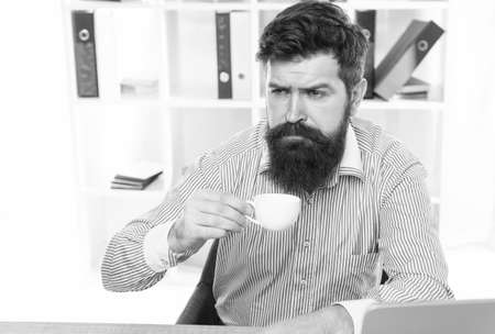 Getting hot drink. Tired employee drink coffee in workplace. Healthy drinking habit. Coffee break. Office life. Drinking daily cup helps you feel more energizedの写真素材