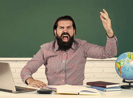 angry man having bad results of exams on remote lesson, school educationの写真素材