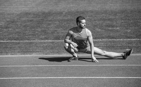 mature man stretching his legs before a stadium workout, stretch