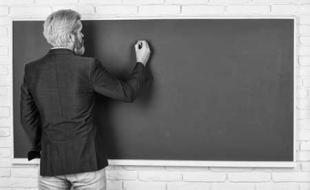 Take placement test. Teacher wanted. Teachers enlighten path of success. Teacher explain topic. Man teacher in front of chalkboard copy space. Announcement of free courses. Advertisement conceptの写真素材