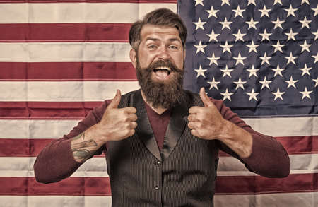 Man with beard and mustache USA flag background, happy migrant conceptの写真素材