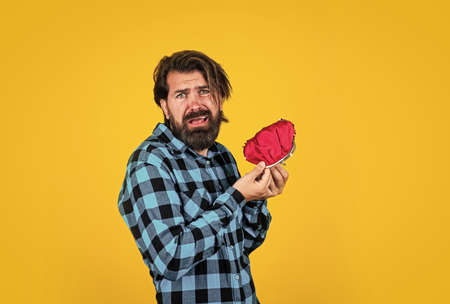 casual guy need some money. unhappy hipster with moustache hold wallet. financial crisis and loan. money saving concept. lets go shopping. bearded man in checkered shirt hold purseの写真素材
