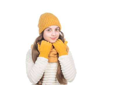cheerful teen girl in knitted hat scarf and gloves warm clothes isolated on white copy space, cold weather.の写真素材