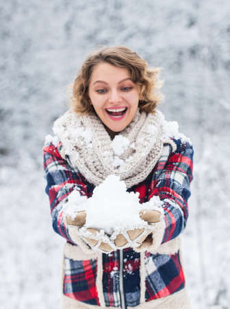 its cold. woman warm clothes in snowy forest. trees covered white snow. girl have fun playing snowball. frosty and funny weather. winter holiday activity. cheerful woman enjoy xmas vacationの写真素材