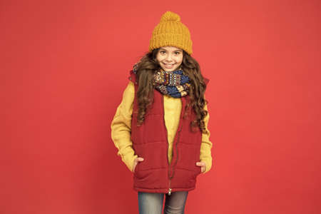 Winter sports. teen child in puffer waistcoat and knitwear. seasonal kid fashion. christmas holiday and vacation. cute beauty keep warm. weather forecast. cheerful girl ready for winter activityの写真素材