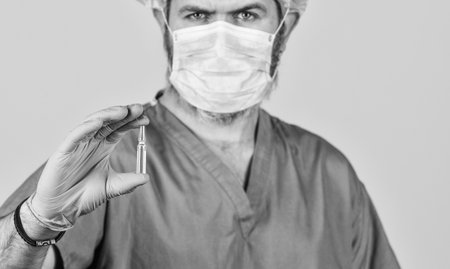 medical specialist hold test tube, selective focus. doctor wear respirator mask. nurse with coronavirus vaccine. pandemic or flu treatment. have immunity. New type pneumonia. Doctors work on symptomsの写真素材
