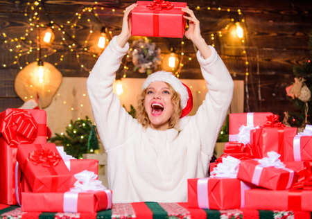 December happy moments. Festive mood. Beautiful wrapped gifts. Happy woman and bunch of gifts boxes. Girl ready for celebration. Gifts integral part of new year celebration. Intrigued conceptの写真素材