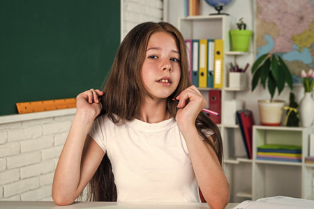 stylish schoolgirl studying homework during lesson online education concept, study well