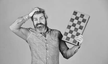 Exercise for brain. Chess figures. Intellectual games. Intelligent bearded hipster. Cognitive skills. Game strategy concept. Chess lesson. Teacher chess competition. Board game. Man playing chessの写真素材