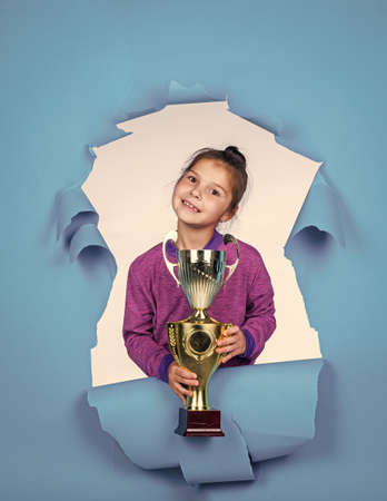 Dedicated to fitness. smiling child with championship cup. childhood happiness. pretty teenage girl in sportswear. kid fitness champion. healthy lifestyle. happy competition winner. best reward everの写真素材