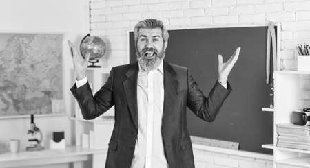 Verify achieved learning outcomes. Teacher school lesson. Study and education. Modern school. Knowledge day. Back to school. Emotional bearded man in classroom chalkboard. Teaching with interestの写真素材