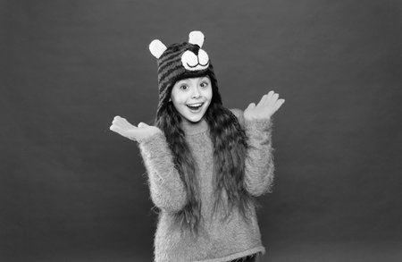 cheerful kid wearing comfortable warm clothes for cold weather forecast on winter xmas holiday and vacation, seasonal shoppingの写真素材