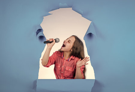 Born to rock. child have fun on party. happy singer with microphone. girl singing. vocal school concept. karaoke club. music is my life. kid sing with mic. cheerful event managerの写真素材