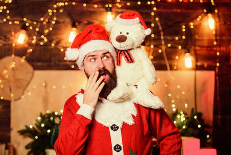 Spread joy happiness. Celebrate new year. Winter fundraising ideas. Kindness and generosity. Charity for kids. Man bearded Santa claus play soft toy teddy bear. Christmas charity. Charity helpの写真素材