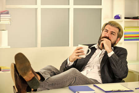 employee during working day in office. working from home while virus epidemic. handsome CEO. Busy mature man in office. Businessman with coffee cup. businessman in officeの写真素材