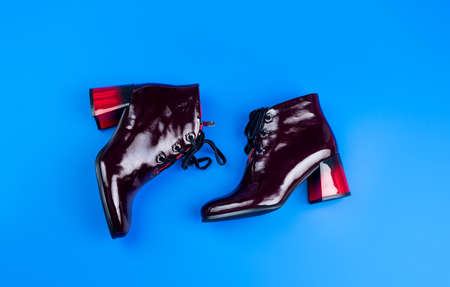 stylish leather high heel boots on blue background, fashionの写真素材