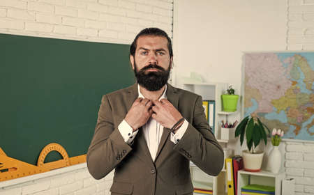 morning grooming. process of studying. informal education. male student in school classroom while lesson. ready to pass the exam. learning the subject. serious man with beard wearing formal suitの写真素材
