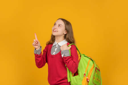 concept of education. kid on yellow background. september 1. happy childhood.の写真素材