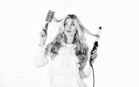 We give you the style. Hairstyle with hair. Curly Hair. Using Curling Iron. Stylist curling for young woman. curls hairstyle. Girl with long blonde blowing curly hair. womens beautiful curly hairの写真素材