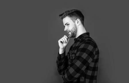 well groomed hairstyle. male beauty and fashion look. hipster checkered shirt for bearded guy. unshaven handsome man with bristle. hairdresser concept. young and confidentの写真素材