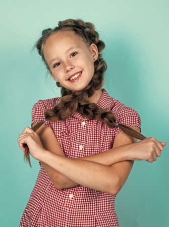 happy teen girl with braided hair in pigtails, childhoodの写真素材