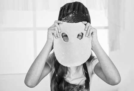 girl having fun while cooking, funny faceの写真素材