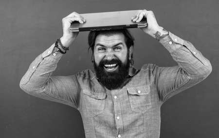 mature bearded man teacher in school classroom with blackboard, online educationの写真素材
