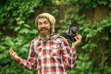 Camera settings concept. Find perfect angle. Bearded man hipster taking photo. Photography in modern life. Hobby and professional occupation. Photographer use vintage camera. Man with retro cameraの写真素材