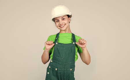 Foreman inspector. future engineer. happy kid wearing uniform for repairing. building construction...
