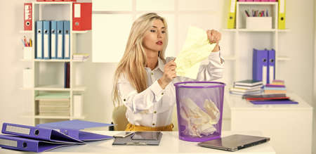 office spy. crumpled paper in wastepaper basket. girl reading piece of paper. office worker digging...