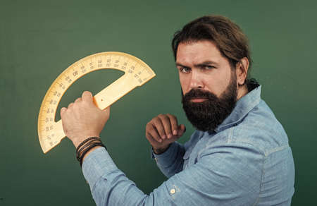 armed with knowledge. teachers day. brutal man with beard use mathematics tools. informal education. male student sit in classroom while lesson. pass the exam. learning the subject. back to schoolの写真素材