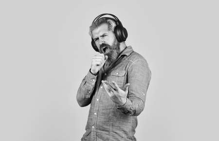 Singer on rehearsal. Music beat. Noise cancelling function. Man bearded hipster headphones listening music. Dj hipster. Excellent music playlist. Hipster enjoy excellent sound song in earphonesの写真素材