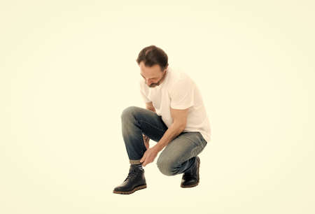 Twisted jeans trend. Discover latest styles of clothes. Casual and comfortable. Menswear and fashionable clothing. Man casual style. Casual outfit. Fashion concept. Handsome model. Basic clothesの写真素材