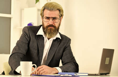 Raising standards. Office staff concept. Business solutions. Risky business. Man bearded boss sit with laptop. Manager solving business problems. Intellectual task. Financial analytics. Stock marketの写真素材