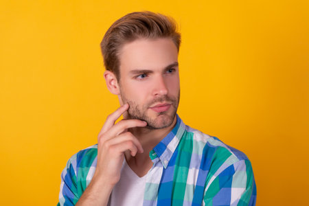 So serious. Mans portrait yellow background. Portrait of guy with straight face. Handsome dudeの写真素材