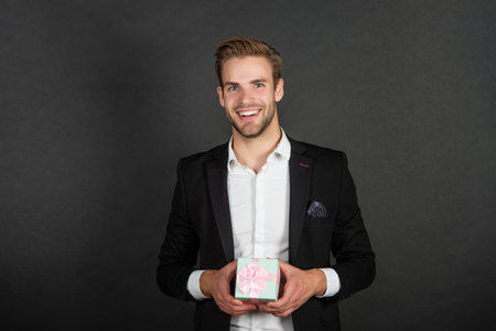 happy man with wrapped box on black background, boxing dayの写真素材
